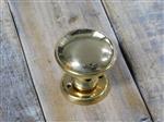 Deurknop met knop rozet, messing gepolijst glanzend, en draaibaar.