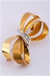 Gouden strik broche met diamanten