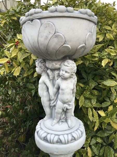 Grote foto prachtige zware bloempot vaas uit vol steen gedragen door engelen. tuin en terras tuindecoratie