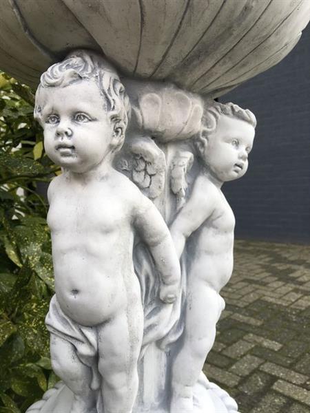 Grote foto prachtige zware bloempot vaas uit vol steen gedragen door engelen. tuin en terras tuindecoratie